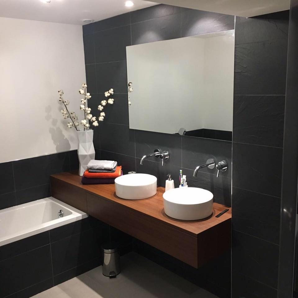 Salle de bains en carreaux d'ardoise noire, plan en bois et deux vasques